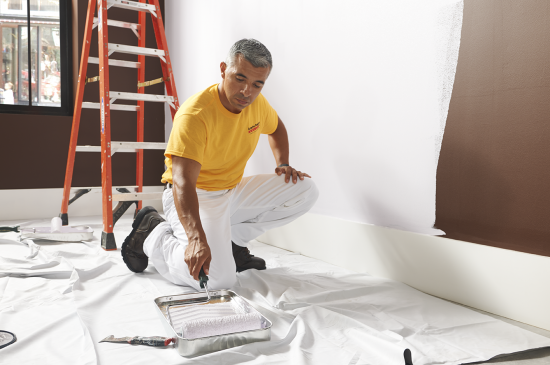 interior house painters with a roller and paint tray.