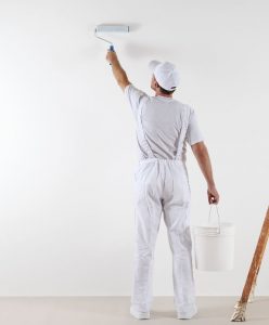 man painting interior wall