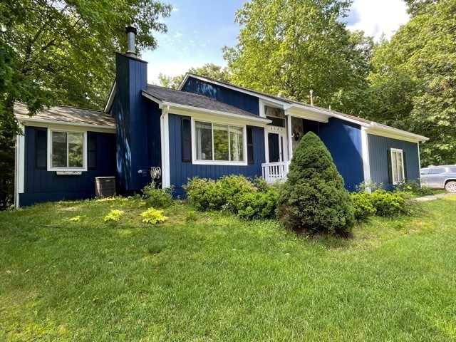 exterior of house painted blue with white trim and black shutters. Preview Image 3