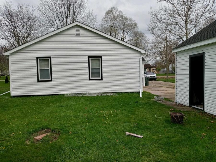 Side of house painted white with black window trim. Preview Image 3