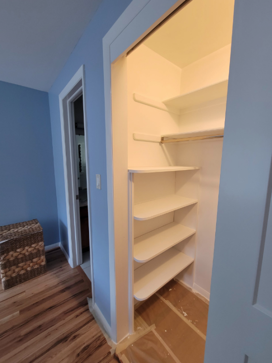 A lit closet ready with a fresh coat of white paint