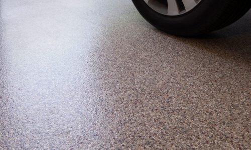 Car,In,Garage,With,Epoxy,Floor,Coating,Over,Concrete.