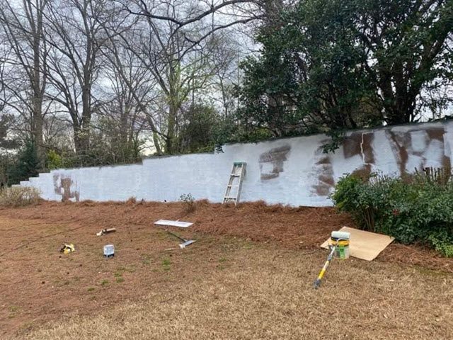 in progress photo of retaining wall being painted Preview Image 1