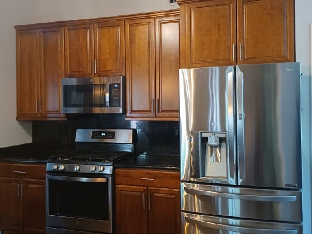 photo of kitchen cabinets before being repainted Preview Image 1