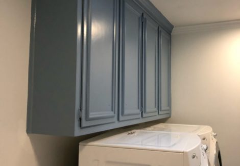 repainted cabinets in a laundry room in a house in alpharetta, georgia