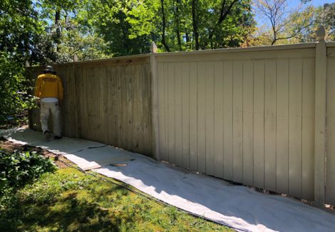 in progress photo of restained fence in marietta ga by certapro painters of roswell