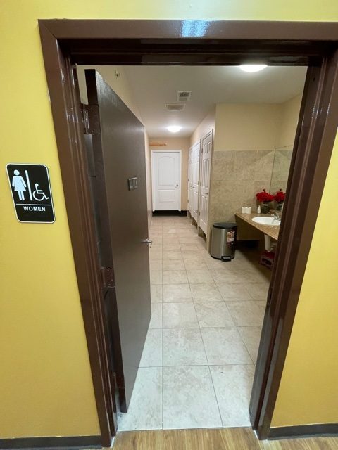 public bathroom space view painted gold on the outside light beige on the inside Preview Image 3