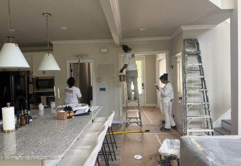3 people painting kitchen walls