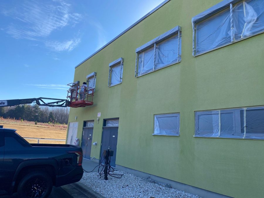 painters on lift against yellow building Preview Image 6