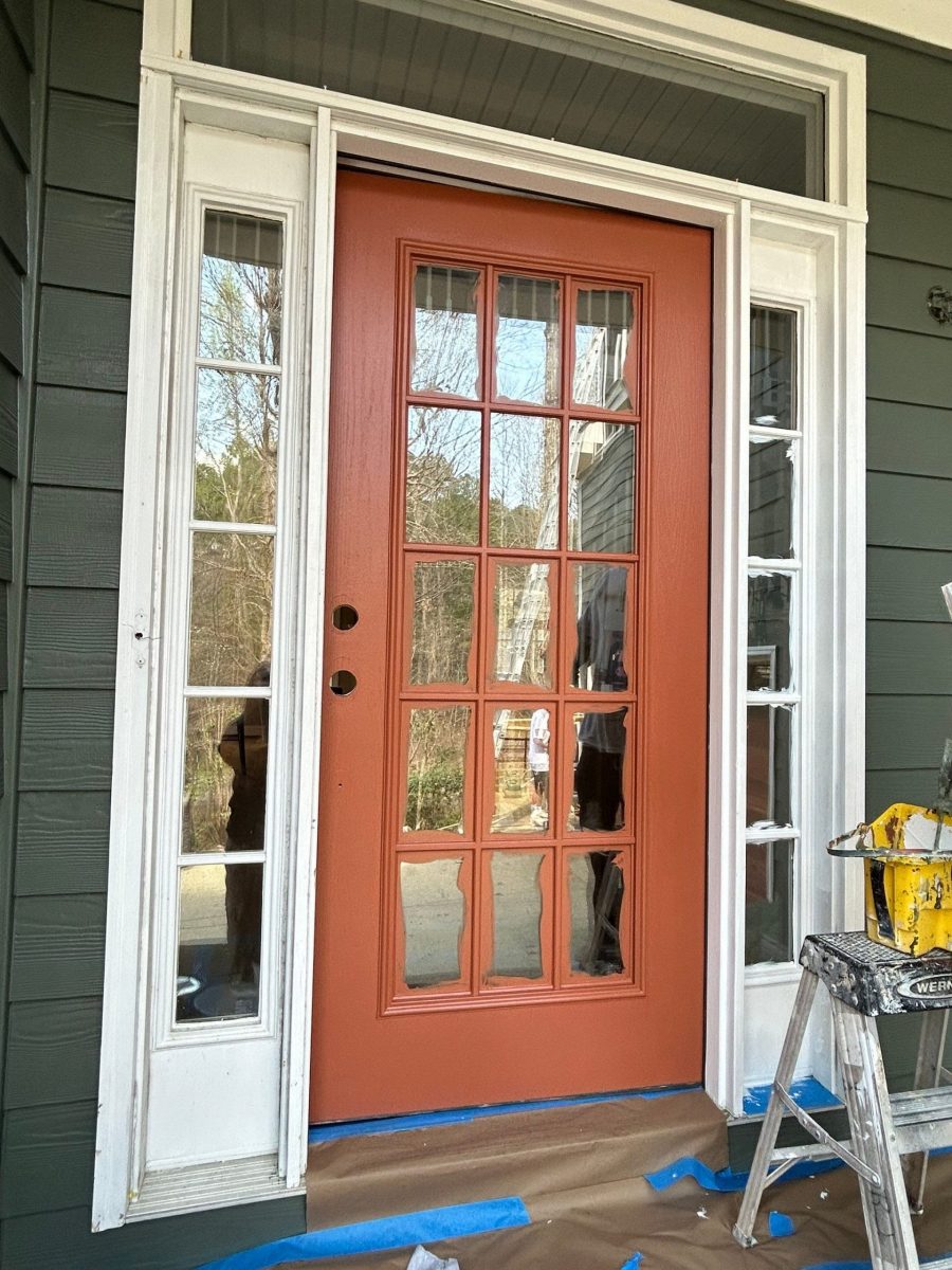 home exterior entryway with blue siding and orange painted door Preview Image 10