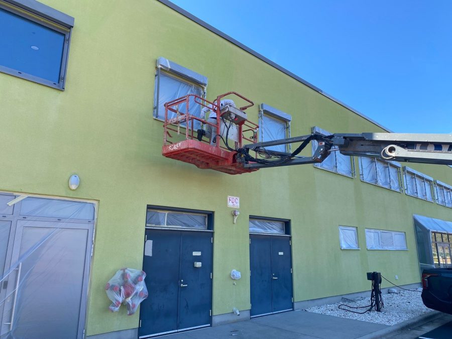 painters on lift against yellow building Preview Image 7