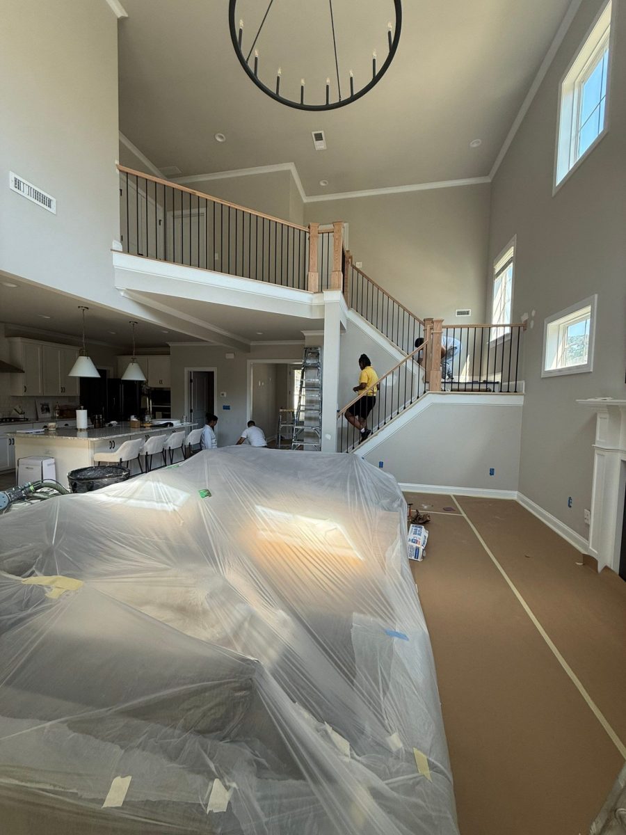 home interior with protective coverings during painting project Preview Image 5