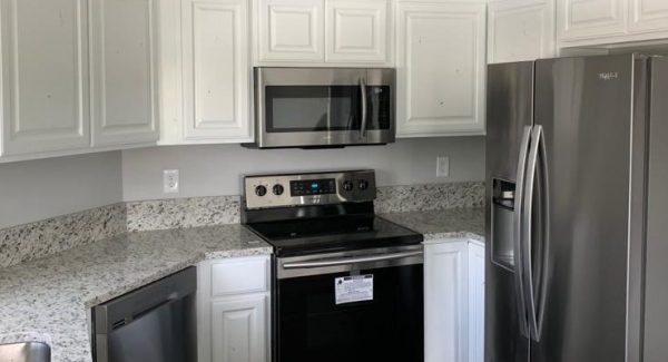 Kitchen cabinets refinished with a bright white