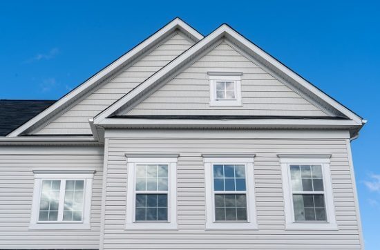 upper half of grey house with vinyl siding