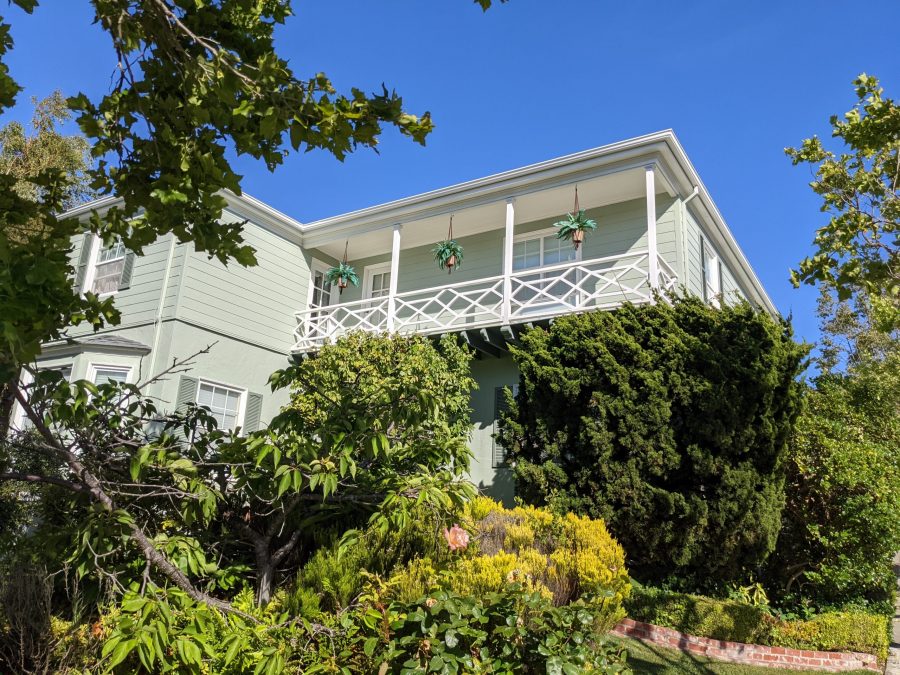 light green home surrounded by dark green foilage Preview Image 2