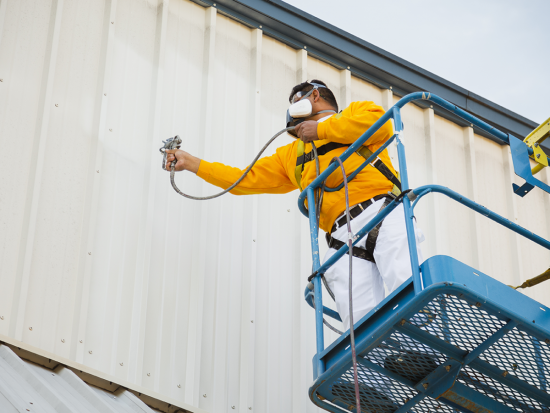 Commercial Painting man painting warehouse exterior