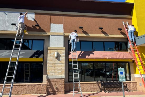 off hours production services men working on ladders