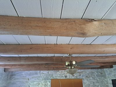 white painted wood ceiling with exposed wood beams