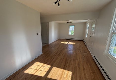 interior room in house with wooden floors and dirty and worn paint on walls