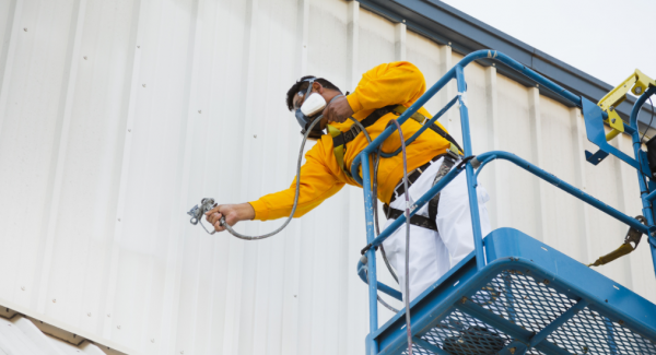 commercial painter using a lift in northwest arkansas