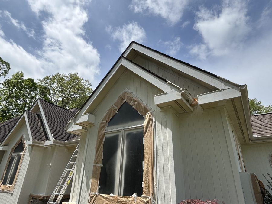 windows of house with protective covering during painting Preview Image 7