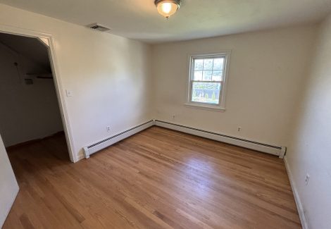 interior room in house with wooden floors and dirty and worn paint on walls