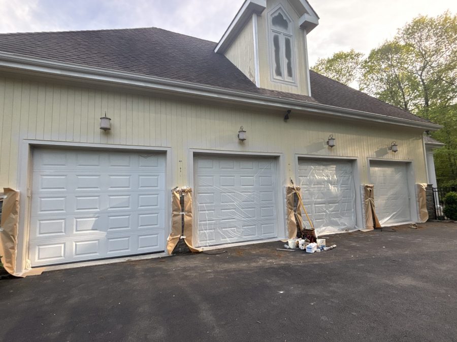 garage side of house with protective covering during painting Preview Image 8