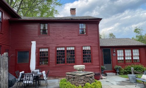 New gutters & downspouts were installed to match the house color, and metal strap hinges got new paint.