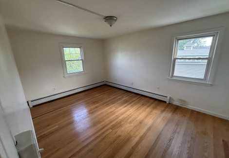 interior room in house with wooden floors and dirty and worn paint on walls