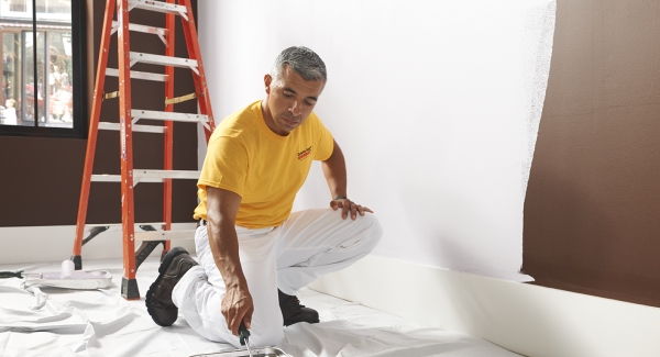 interior house painters with a roller and paint tray.