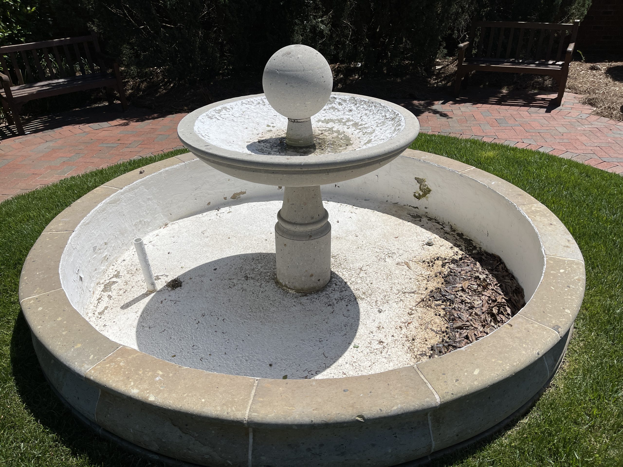 old garden water fountain with chipped paint