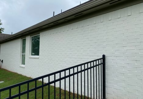 Brick house painting project after completion.