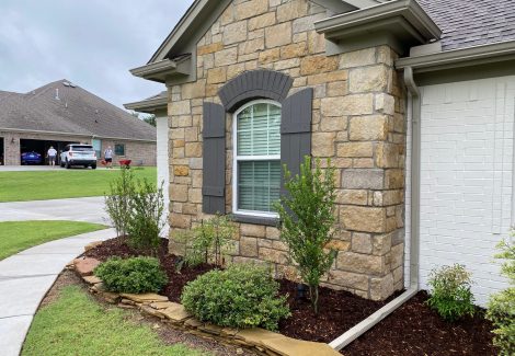 Masonry painters at work on a house.
