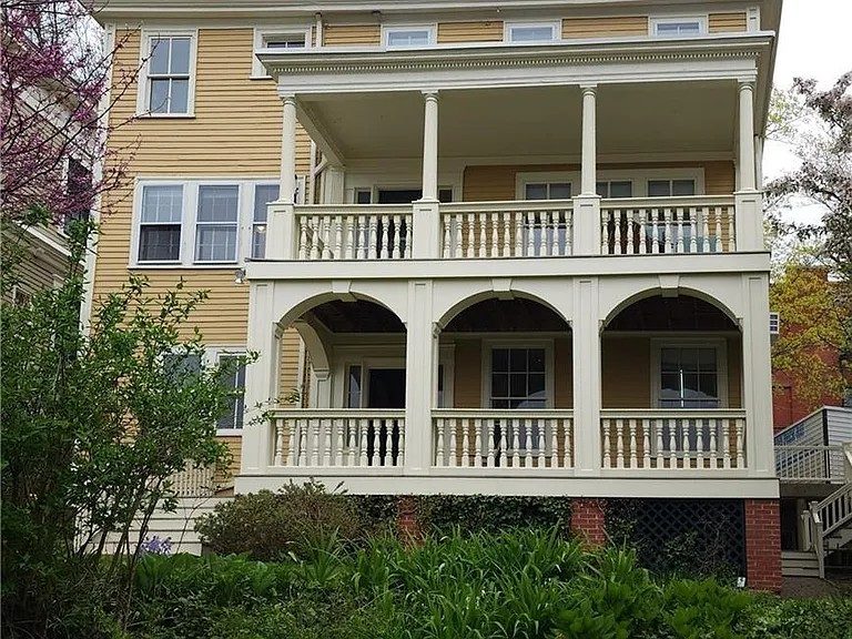 yellow painted historical home exterior and rear porches Preview Image 4