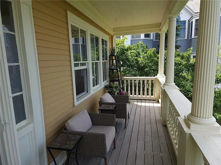 yellow painted historical home exterior and front porch Preview Image 2