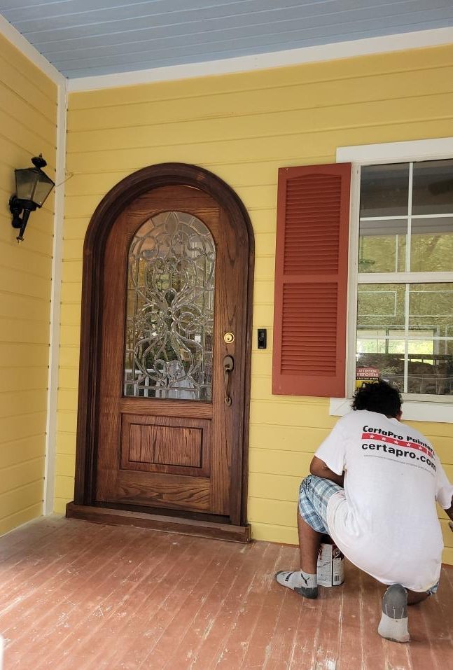 painter staining front door Preview Image 2