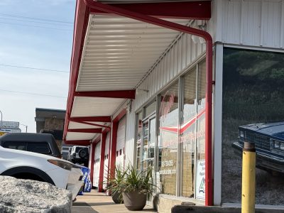 white and red trim painted auto body shop exterior