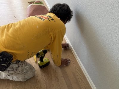 painter working on lower wall trim