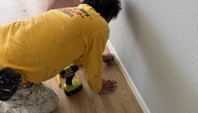 painter working on lower wall trim