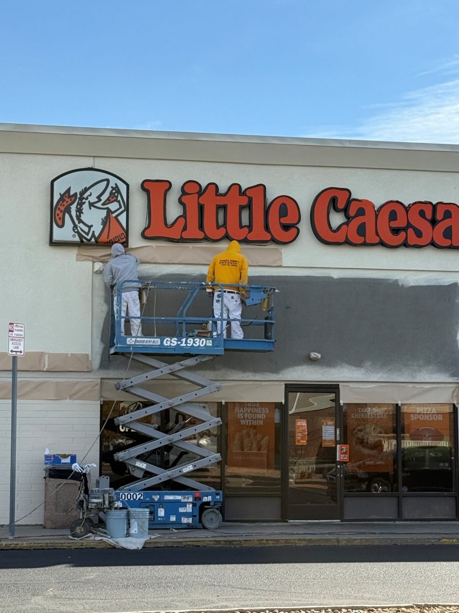 team members on scissor lift painting shopping center marquee Preview Image 4