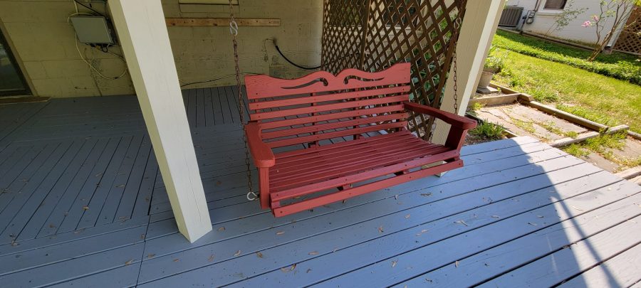 red swinging bench on deck after painting Preview Image 7