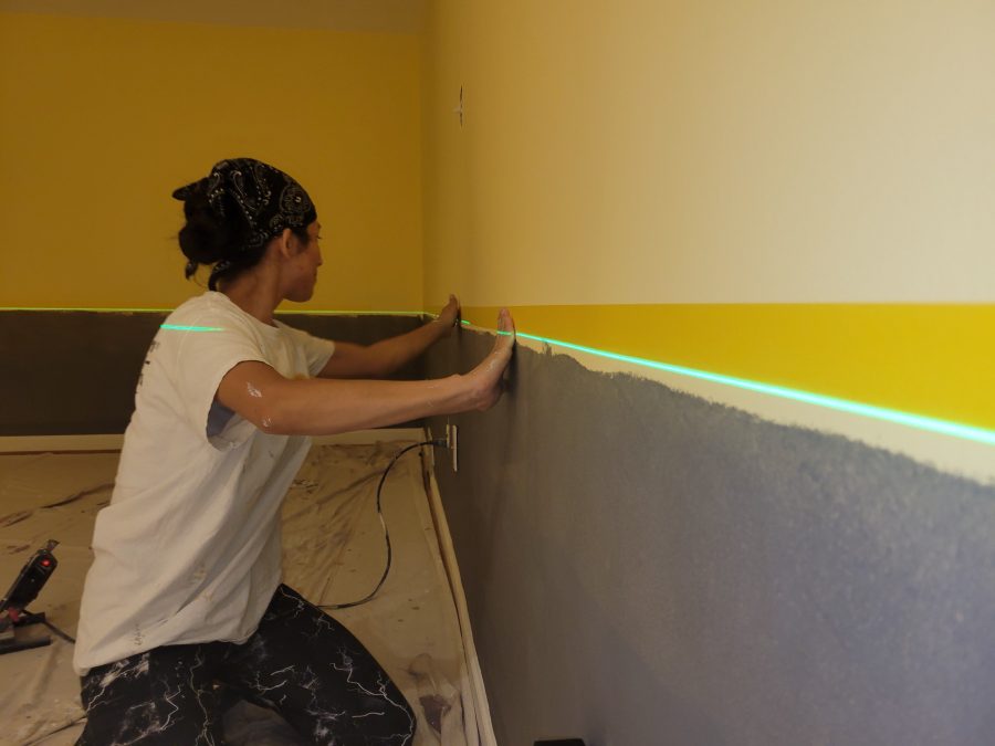 woman using lazor level during interior paint project Preview Image 12