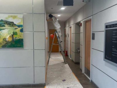hallway work being done by certapro team member in commercial building