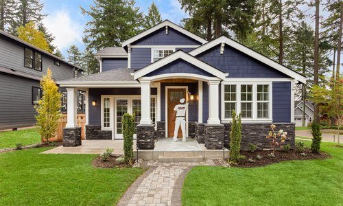 CertaPro Painter painting the front of a blue house