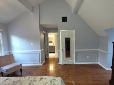 bedroom with lilac painted walls and white trim