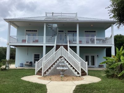 front view of blue home with white trim in st. augustine