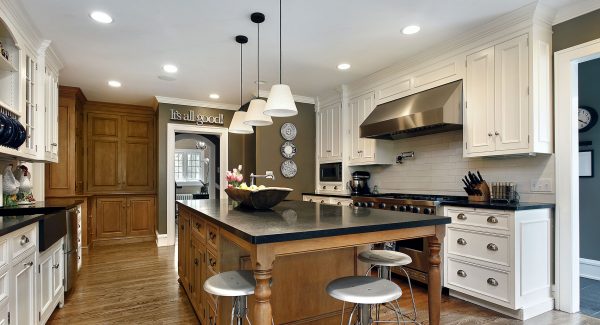 modern farmhouse kitchen with green walls and white cabinets