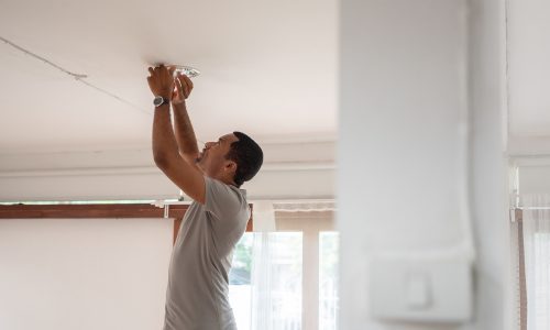 Man changing ceiling light fixtures