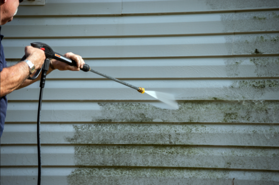 removing dirt with power washer