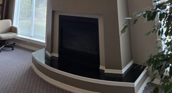 interior room with fireplace painted beige with white trim